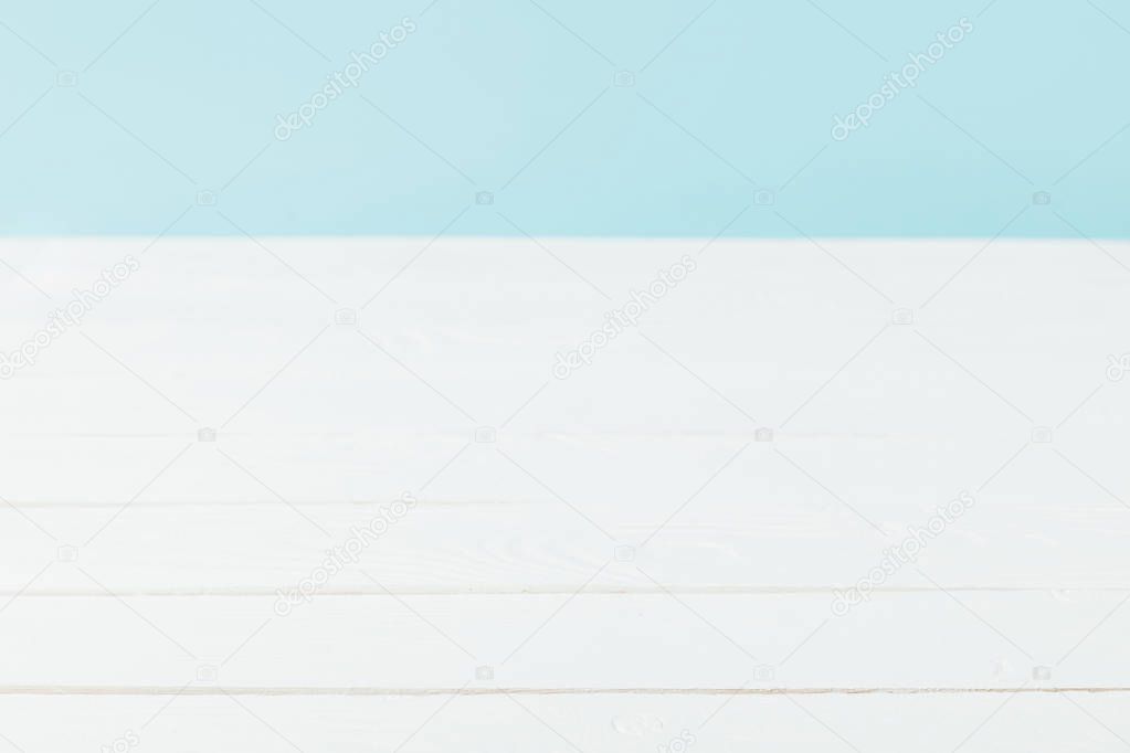 full frame of white wooden tabletop and blue background