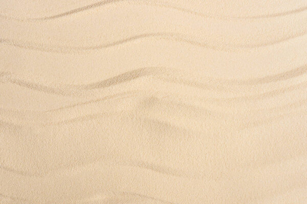 Texture of sandy beach with smooth waves