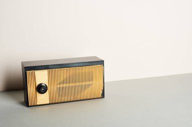 Retro radio on grey surface and white background clipart