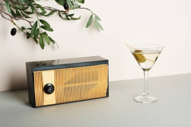 Vintage radio with martini and olive branch on white background clipart