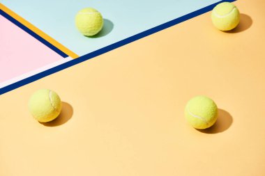 Tennis balls with shadow on colorful background with blue lines clipart