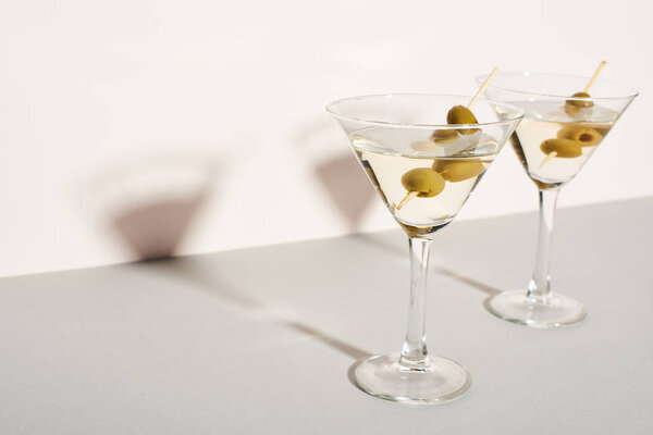 Martini cocktails with olives on white background 