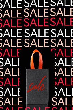 paper shopping bag with red handle isolated on black with sale illustration  clipart