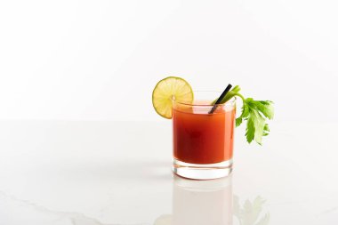 bloody mary cocktail in glass garnished with lime and celery isolated on white clipart