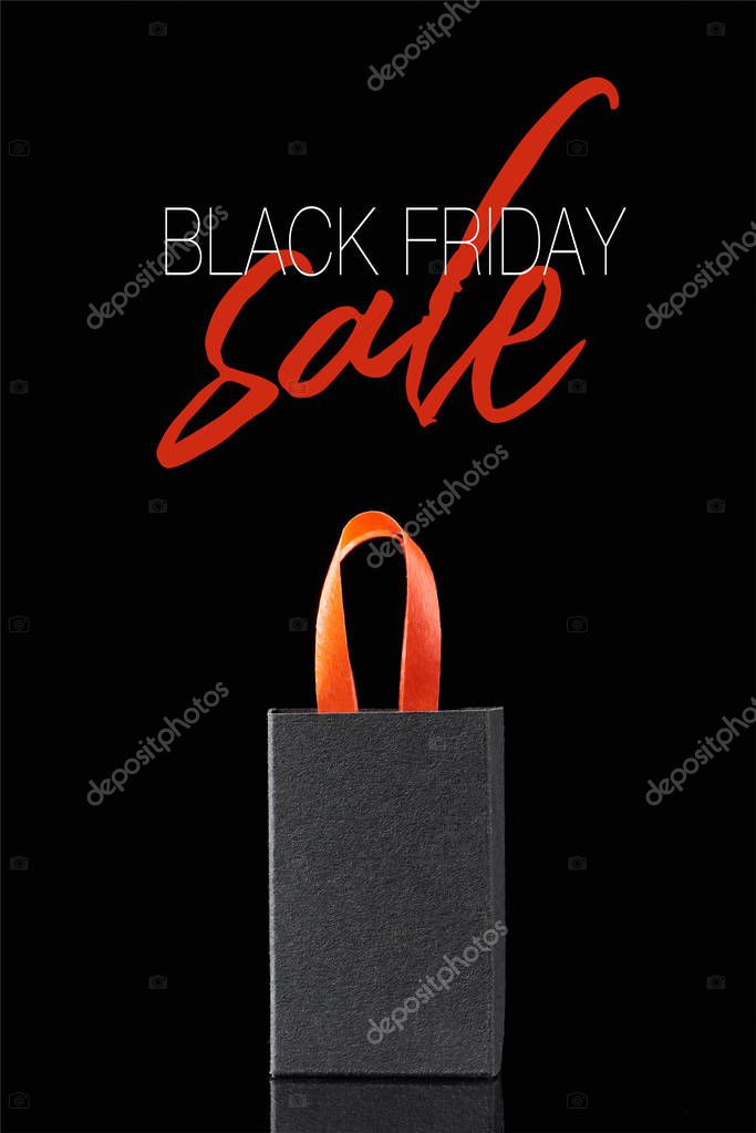 Paper shopping bag with red handle isolated on black with black Friday sale illustration