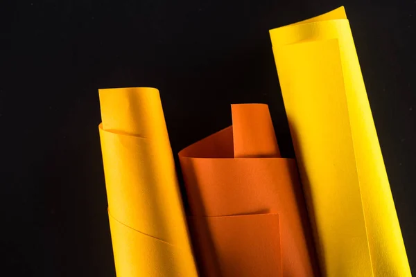 Rolled color papers isolated on black — Stock Photo