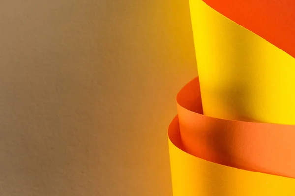 Close-up shot of rolled yellow and orange papers for background — Stock Photo