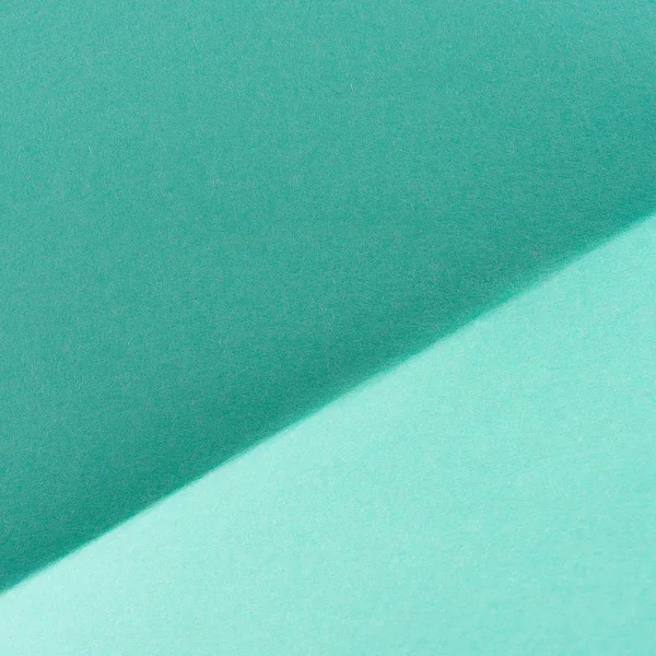 Close-up shot of turquoise color folded paper for background — Stock Photo