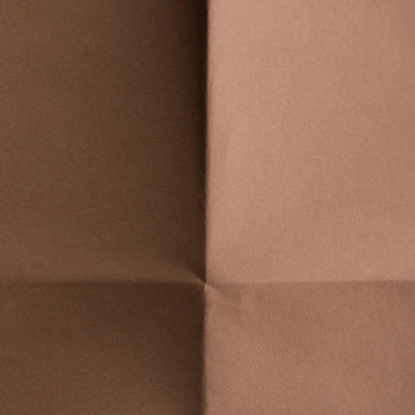 Close-up shot of brown colored folded paper for background — Stock Photo