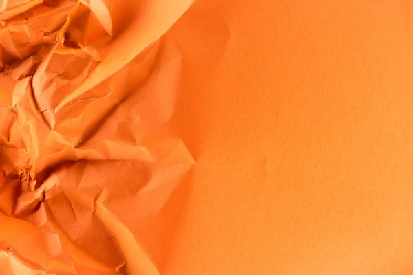 Close-up shot of orange crumpled paper for background — Stock Photo