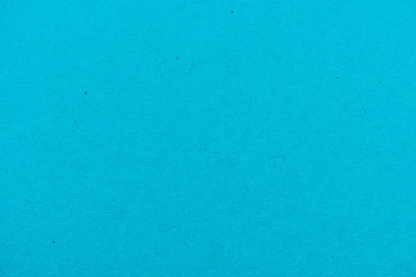 Текстура голубой цветной бумаги в качестве фона — стоковое фото