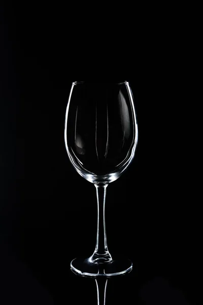 One wineglass on black reflecting tabletop — Stock Photo