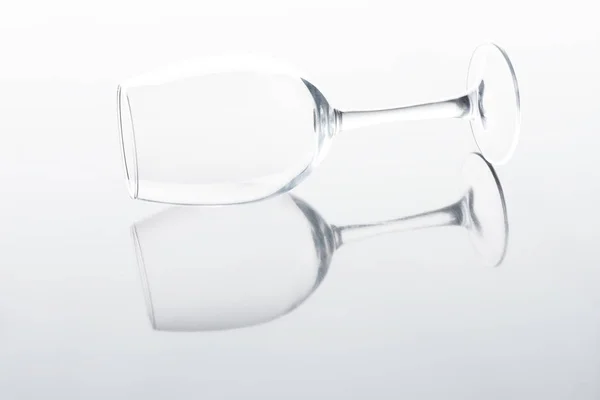 One wineglass on white reflecting tabletop — Stock Photo