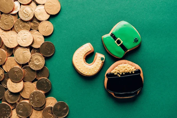 Vista superior de las galletas de hielo y monedas de oro en verde, st patricks concepto de día - foto de stock