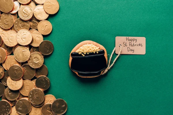 Top view of icing cookie and golden coins on green, st patricks day concept — Stock Photo