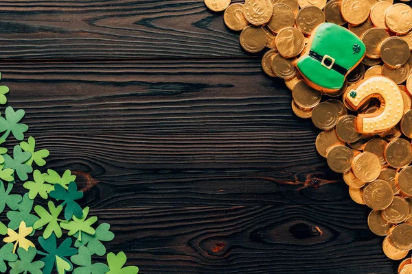 Top view of shamrock and golden coins on wooden table, st patricks day concept — Stock Photo
