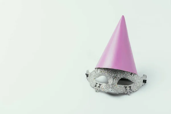 Close up view of masquerade mask and party cone isolated on grey — Stock Photo