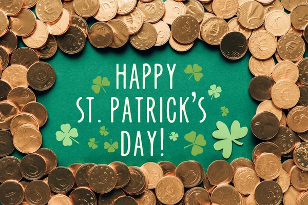 Flat lay with golden coins and happy st patricks day lettering on green background — Stock Photo