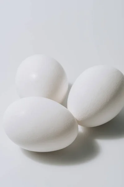 White eggs laying on white background — Stock Photo