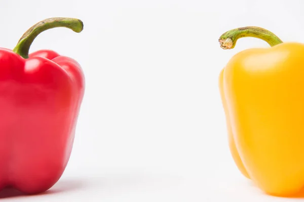 Red and yellow bell peppers, on white background — Stock Photo
