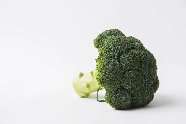 Green raw brocolli laying on white background — Stock Photo
