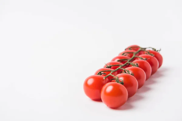 Raw cherry tomatoes laying on white background — Stock Photo