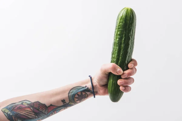 Hand holding green cucumber isolated on white background — Stock Photo