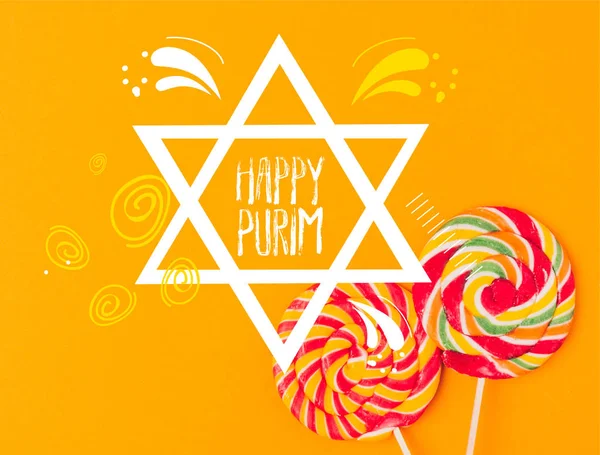 Top view of sweet lollipops isolated on orange, purim holiday concept — Stock Photo