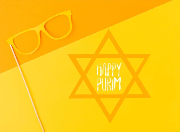 Top view of masquerade mask on yellow and orange background, purim holiday concept — Stock Photo