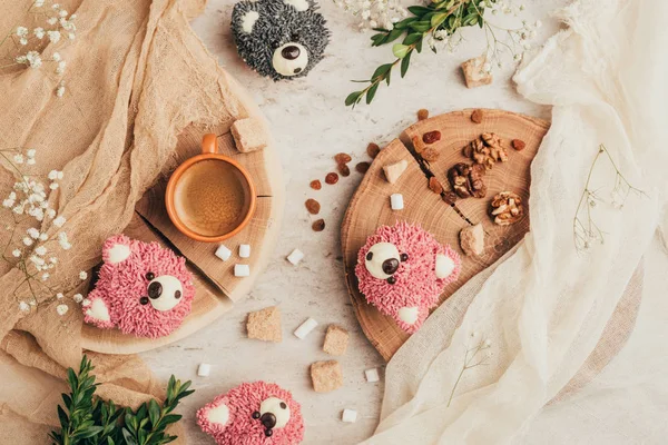 Top view of delicious cupcakes in shape of bears with sugar and raisins on table — Stock Photo