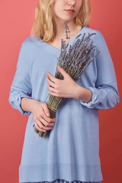 Cropped shot of woman with bouquet of lavender flowers isolated on red — Stock Photo