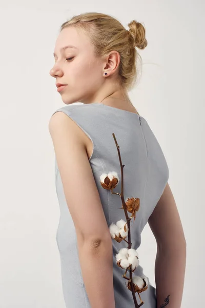 Sensual young woman with cotton branch isolated on white — Stock Photo