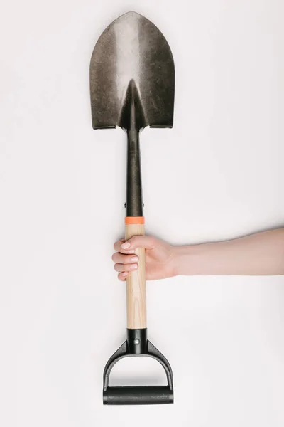 Partial view of female hand with shovel isolated on white — Stock Photo