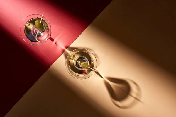 Top view of martini with olives on red and beige background — Stock Photo