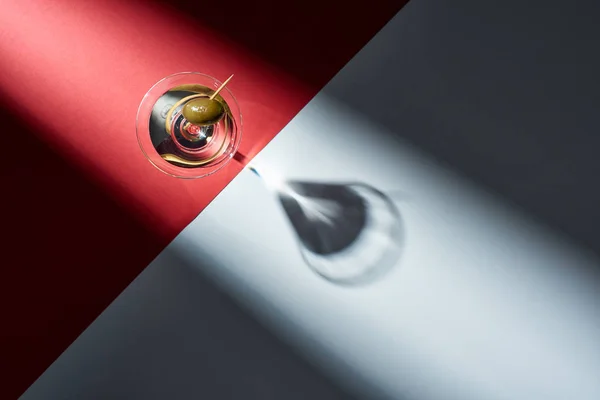 Top view of martini with shadow on red and grey background — Stock Photo