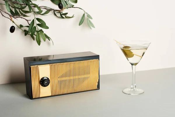 Vintage radio with martini and olive branch on white background — Stock Photo