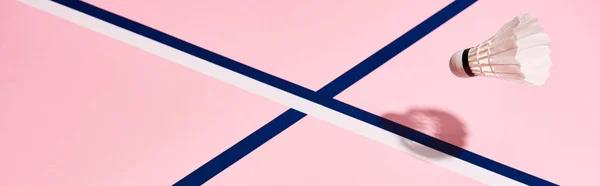 Badminton shuttlecock on pink surface with blue lines, panoramic shot — Stock Photo