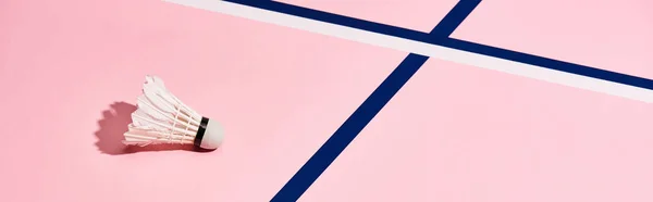 Shuttlecock for badminton on pink surface with blue lines, panoramic shot — Stock Photo