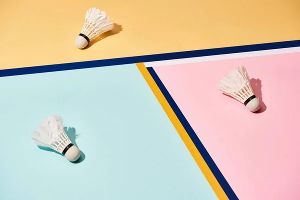 Badminton shuttlecocks on colorful background with blue lines — Stock Photo