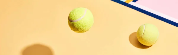 Two tennis balls with shadow on colorful background with blue lines, panoramic shot — Stock Photo