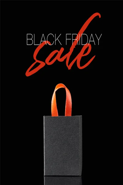 Paper shopping bag with red handle isolated on black with black Friday sale illustration — Stock Photo