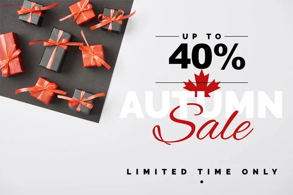 Top view of presents on white and black background with up to 40 percent autumn sale illustration — Stock Photo