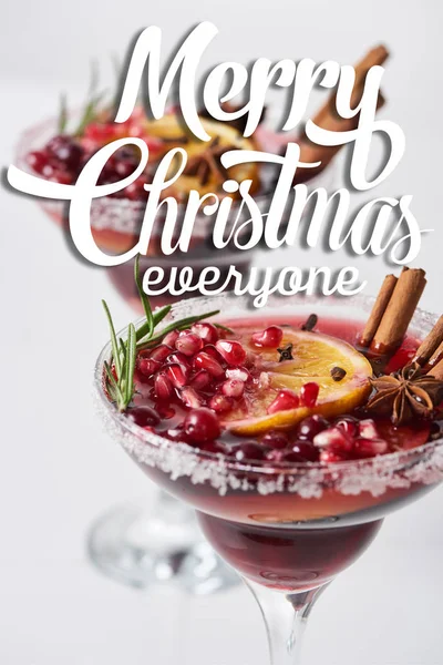 Selective focus of christmas cocktail with orange, pomegranate, cinnamon with merry christmas everyone illustration — Stock Photo