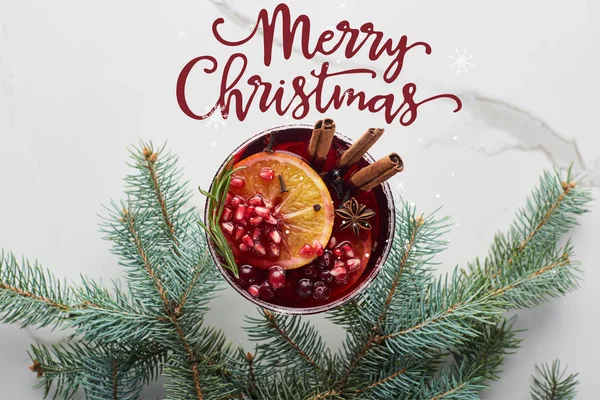 Top view of christmas cocktail with orange, pomegranate, cinnamon with merry christmas illustration — Stock Photo