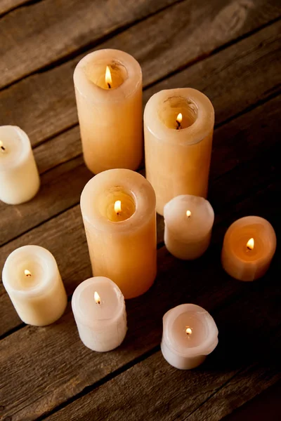 Burning candles on wooden table on christmas eve — Stock Photo