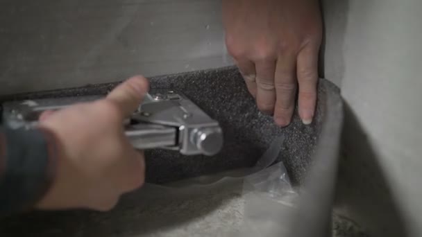Damper tape for styling. Worker fastens damper tape. The tape is attached to the floor to fill the floor. — Stock Footage Damper tape for styling. Worker fastens damper tape. The tape is attached to the floor to fill the floor. Royalty Free Stock Footage