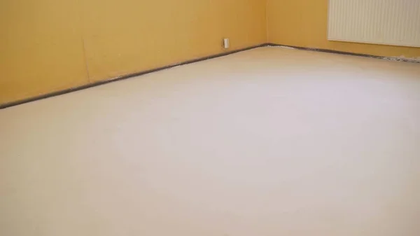 White floors that the worker did. Floor made with mortar. empty white room interior in residential house building with tile flooring and window pvc replacement decoration