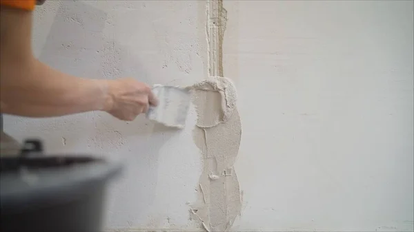 Hands Plasterer at work. Application of the plaster on the wall. textured plaster. Plastering the wall.