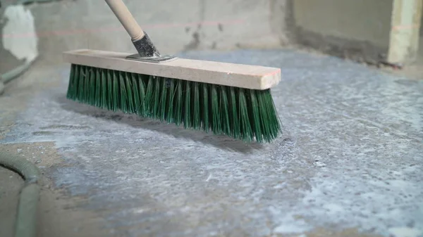 Workers apply a polymer waterproofing form of memory. Workers flood the floor. Liquid flooring. Leveling the floor with a liquid composition. Industrial worker at a cement waterproofing construction site.