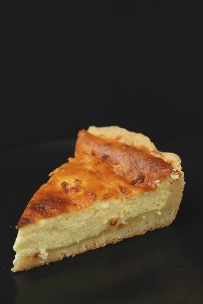 Homemade Delicious sweet Cottage Cheese, Vanilla Pie with cut out Slices on Black Slate, view from Above. — Stock Photo, Image